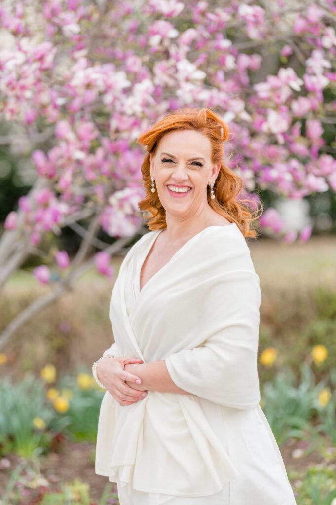 Bride smiling with spring flowers in the background