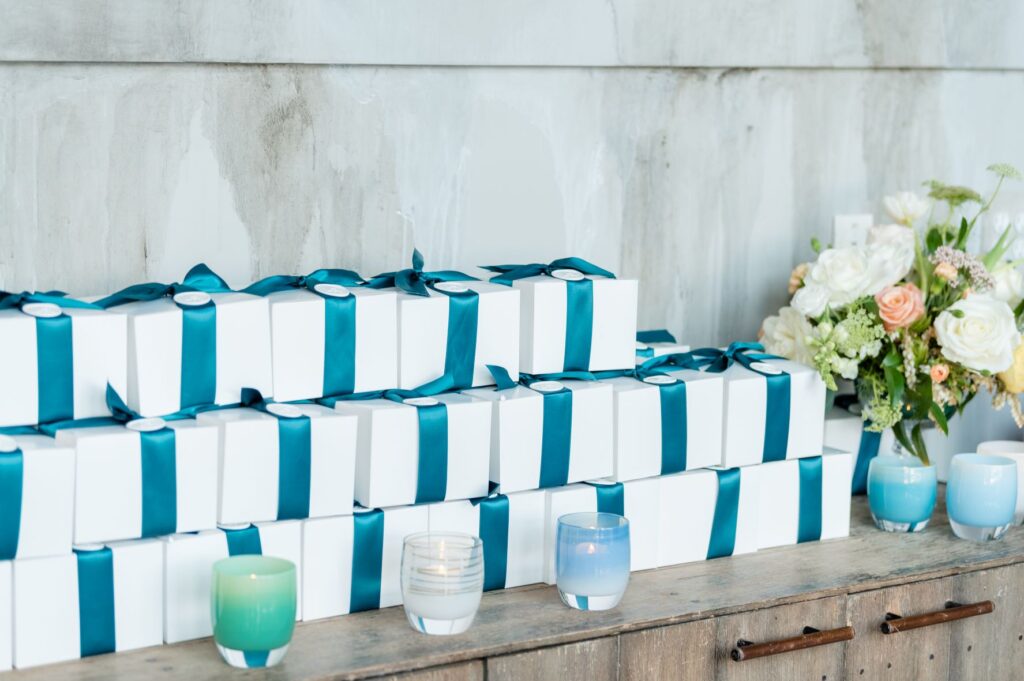 Gift boxes with teal ribbon and wax seal