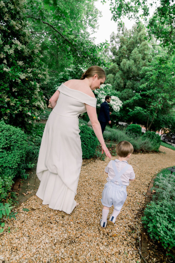 Bride and son walking away from camera