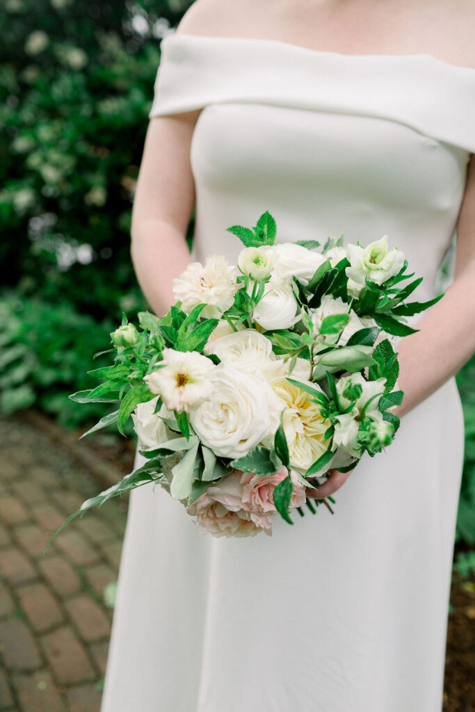 Bride's bouquet of white and pink flowers with greenery